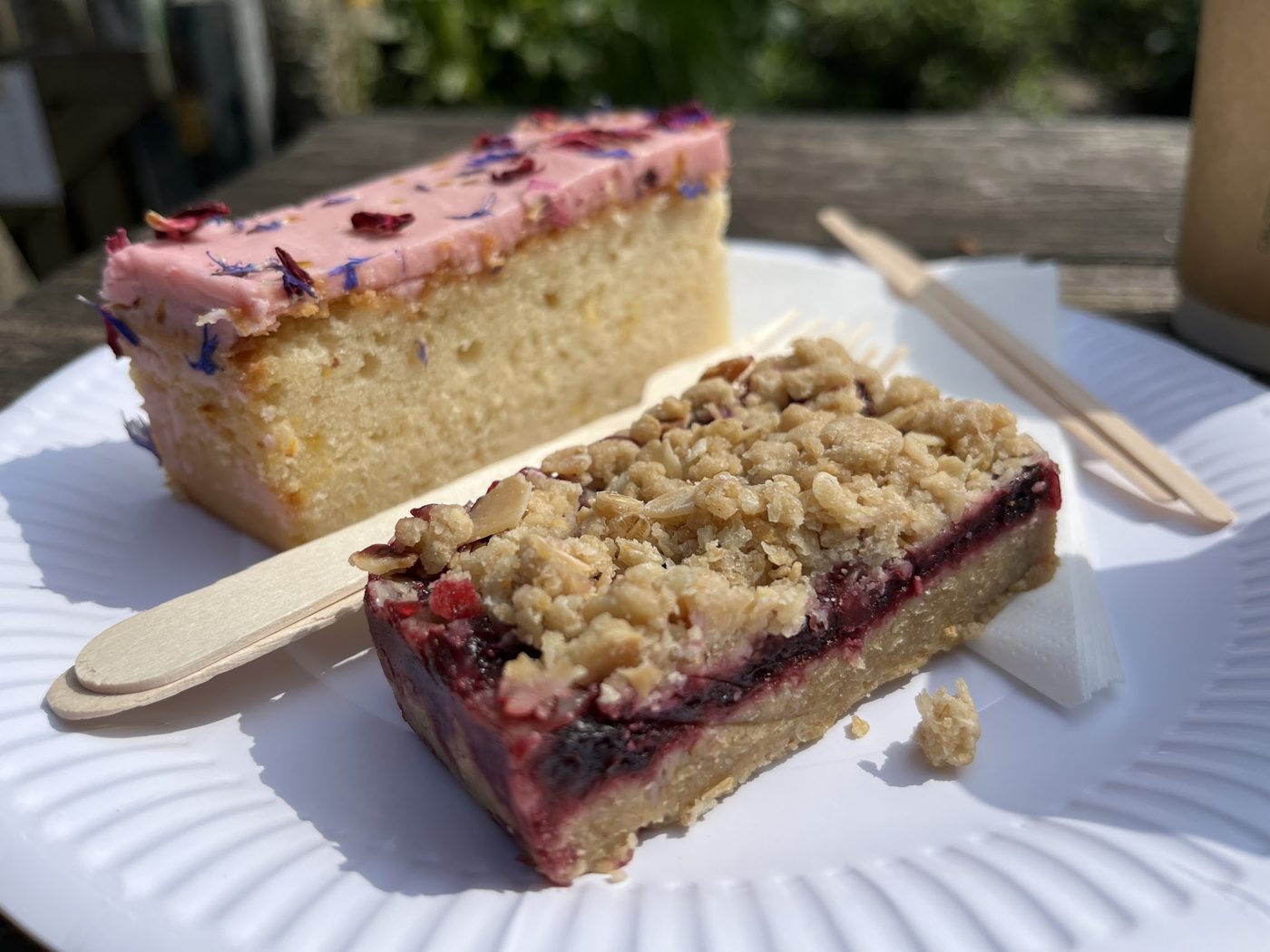 Two slices of fruit traybake on a paper plate